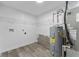 Utility room features washer-dryer hookups, vinyl plank flooring, and a hot water heater at 4057 Knollwood Ave, Franklin, IN 46131