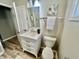 Bright bathroom featuring a modern vanity, toilet, and stylish fixtures, complemented by soft natural light at 4205 Rookwood Ave, Indianapolis, IN 46208