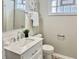 Renovated bathroom features updated vanity with marble countertop and bright glass block window at 4205 Rookwood Ave, Indianapolis, IN 46208