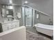 Contemporary bathroom featuring a soaking tub, walk-in shower, and bright neutral decor at 4205 Rookwood Ave, Indianapolis, IN 46208