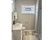 Bright bathroom featuring a new vanity, modern fixtures, and unique glass block window at 4205 Rookwood Ave, Indianapolis, IN 46208