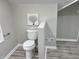 Bathroom with a white toilet and grey walls at 4205 Rookwood Ave, Indianapolis, IN 46208