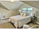 Cozy bedroom with dormer ceilings, plush bedding, and natural light at 4205 Rookwood Ave, Indianapolis, IN 46208