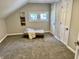 Bedroom featuring a tufted ottoman, neutral decor, and a bright window at 4205 Rookwood Ave, Indianapolis, IN 46208