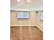 Bright bedroom with neutral walls and plush brown carpeting, illuminated by recessed lighting and natural light from windows at 4205 Rookwood Ave, Indianapolis, IN 46208