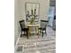 Cozy dining area shows a round table, two chairs, and artwork, creating an intimate eating space at 4205 Rookwood Ave, Indianapolis, IN 46208