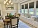 Bright dining room boasts bench seating, a modern chandelier, and neutral tones for a relaxing eating space at 4205 Rookwood Ave, Indianapolis, IN 46208