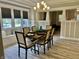 The dining room features a decorative chandelier, neutral decor, and a window bench for enjoying meals at 4205 Rookwood Ave, Indianapolis, IN 46208