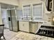 Modern kitchen features stainless steel appliances, white cabinets, and granite countertops for a sleek cooking space at 4205 Rookwood Ave, Indianapolis, IN 46208