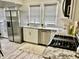 Kitchen with stainless appliances, bright countertops, white cabinets, and a faux fur rug at 4205 Rookwood Ave, Indianapolis, IN 46208