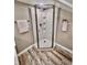 Contemporary shower with glass doors, built-in shelving, and modern fixtures, set against stylish wood-look flooring at 4205 Rookwood Ave, Indianapolis, IN 46208