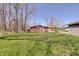 Enjoy the large, grassy backyard with mature trees offering shade and privacy; an outdoor oasis at 4389 S Brooklawn Dr, New Palestine, IN 46163