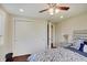 Comfortable bedroom with closet, ceiling fan, and a beautifully decorated bed and nightstand at 4389 S Brooklawn Dr, New Palestine, IN 46163