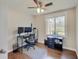 Office/bedroom featuring ceiling fan, natural light, and functional workspace with monitors at 4389 S Brooklawn Dr, New Palestine, IN 46163