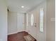 Bright entryway featuring dark hardwood flooring, white trim, and natural light at 4389 S Brooklawn Dr, New Palestine, IN 46163