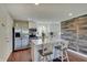 Modern kitchen featuring white cabinetry, stainless steel appliances, and island seating at 4389 S Brooklawn Dr, New Palestine, IN 46163
