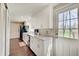 Bright kitchen features white cabinets, stainless steel appliances, and hardwood floors at 4389 S Brooklawn Dr, New Palestine, IN 46163