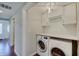 Well-organized laundry area with modern washer, dryer, and ample storage space at 4389 S Brooklawn Dr, New Palestine, IN 46163