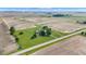 An aerial view showcases a charming property with a large lawn, mature trees, and outbuilding surrounded by farmland at 4545 W 200 S, Lebanon, IN 46052