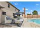 Backyard patio featuring comfortable seating next to a refreshing swimming pool on a sunny day at 4545 W 200 S, Lebanon, IN 46052