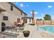Backyard with patio, outdoor seating, brick chimney, and partial view of the in-ground pool at 4545 W 200 S, Lebanon, IN 46052
