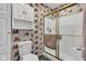A cozy bathroom featuring unique wallpaper and glass enclosed shower at 4545 W 200 S, Lebanon, IN 46052