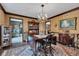 Dining room featuring chandelier, vintage wallpaper, hardwood floors, and wood trim at 4545 W 200 S, Lebanon, IN 46052