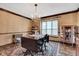 Formal dining area featuring a chandelier, vintage wallpaper, hardwood trim, and a window at 4545 W 200 S, Lebanon, IN 46052
