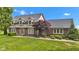 Charming home featuring a brick and siding exterior, dormer windows, a manicured lawn, and tasteful landscaping at 4545 W 200 S, Lebanon, IN 46052