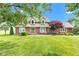 Charming two-story home with brick accents, lush lawn, and beautiful landscaping at 4545 W 200 S, Lebanon, IN 46052