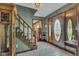 Inviting foyer featuring hardwood floors, staircase, and decorative front door at 4545 W 200 S, Lebanon, IN 46052