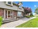 Charming front porch with brick accents and seating area surrounded by beautiful landscaping at 4545 W 200 S, Lebanon, IN 46052