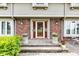 Charming brick-accented porch with seating and mature landscaping at 4545 W 200 S, Lebanon, IN 46052