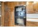 Elegant kitchen featuring oak cabinets, built in oven and microwave appliances, complemented by neutral countertops at 4545 W 200 S, Lebanon, IN 46052