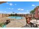Backyard with cozy in-ground pool, patio seating, umbrella, and privacy fence at 4545 W 200 S, Lebanon, IN 46052