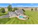 Aerial photo of home with an in-ground pool, patio area, attached garage, and verdant lawn at 4545 W 200 S, Lebanon, IN 46052