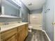 Bathroom features a double vanity, large mirror, and a shower-tub combination at 4767 Kelvington Dr, Indianapolis, IN 46254