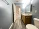 Bright bathroom features a double vanity, a large mirror, and a toilet with modern fixtures at 4767 Kelvington Dr, Indianapolis, IN 46254