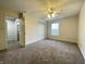 Large bedroom with neutral carpet, ceiling fan, and window overlooking the backyard at 4767 Kelvington Dr, Indianapolis, IN 46254