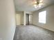 Bright bedroom with neutral carpeting, ceiling fan, and sliding door closet at 4767 Kelvington Dr, Indianapolis, IN 46254