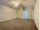 Spacious bedroom with neutral carpet, ceiling fan, and multiple closets for ample storage at 4767 Kelvington Dr, Indianapolis, IN 46254