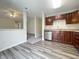Open-concept kitchen featuring modern cabinets, stainless steel appliances, and wood-look flooring at 4767 Kelvington Dr, Indianapolis, IN 46254