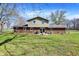 Spacious backyard with a well-maintained lawn, mature trees, and patio, ideal for outdoor enjoyment at 5311 Larita Ln, Anderson, IN 46017