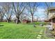 Lush backyard with mature trees and green lawn perfect for relaxation and outdoor activities at 5311 Larita Ln, Anderson, IN 46017