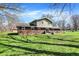 Expansive backyard featuring lush green grass and mature trees creating a serene outdoor space at 5311 Larita Ln, Anderson, IN 46017