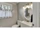 Updated bathroom with window, modern vanity, toilet and mirror with neutral paint at 5311 Larita Ln, Anderson, IN 46017