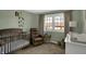 Charming Bedroom with crib, rocking chair, and bright window, perfect for a new Gathering at 5311 Larita Ln, Anderson, IN 46017