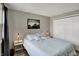 Well-lit bedroom with neutral walls and carpet featuring a comfortable bed and side tables at 5311 Larita Ln, Anderson, IN 46017