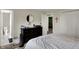 Bedroom featuring a queen bed with striped bedding, complemented by bedside tables and a dark dresser at 5311 Larita Ln, Anderson, IN 46017