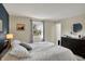 Bedroom featuring a queen bed with striped bedding, complemented by bedside tables and lamps at 5311 Larita Ln, Anderson, IN 46017